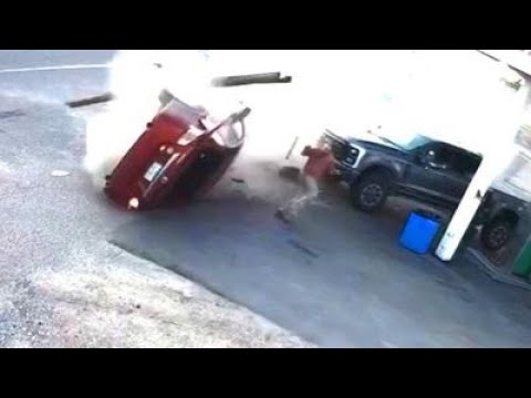 Crashed car slides narrowly past man