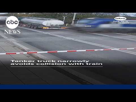Tanker truck narrowly avoids collision with train