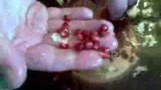 Cut the pomegranate in half, submerge in cold water, and extract the seeds from under the water. They'll release effortlessly from the papery membrane and sink to the bottom of the bowl.