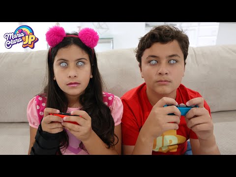 Maria Clara and JP mesmerized by electronic games.