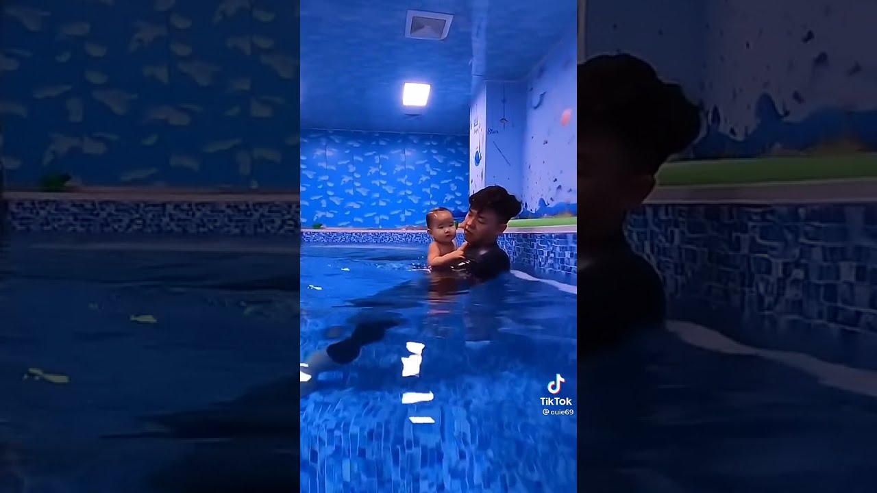 Watch video Dad trains his 5 month old son how to swim 💙 #shorts Now Dad trains his 5 month old son how to swim 💙 #shorts