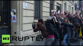 French protesters use chainsaw, battering ram to hack through govt office door