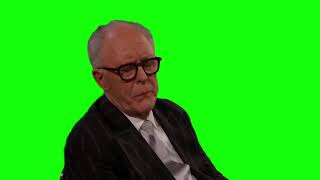 John Lithgow looking slightly disappointed at The Oscars 2025 green screen