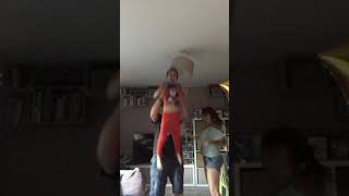 Guy picks up boy and accidentally hits ceiling lamp and cracks light bulb