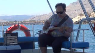 Magic John playing on a boat near Lindos, Rhodes