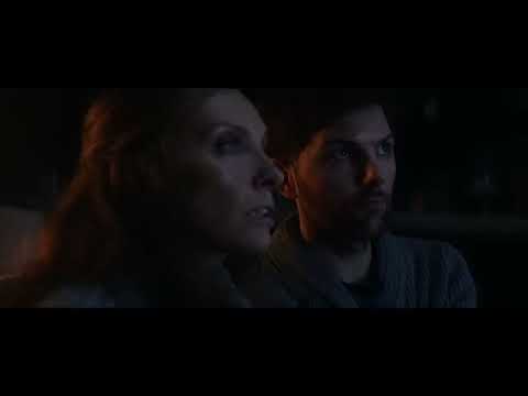 Krampus official trailer frame: a snow-choked suburb under blackout as something vast moves on a rooftop
