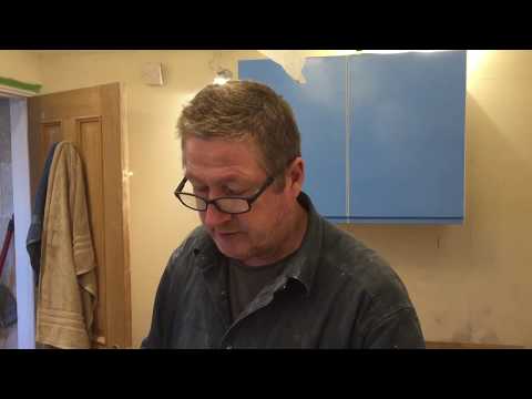 Part of a video titled How to cut IKEA VOXTORP kitchen gloss end panels without chipping ...