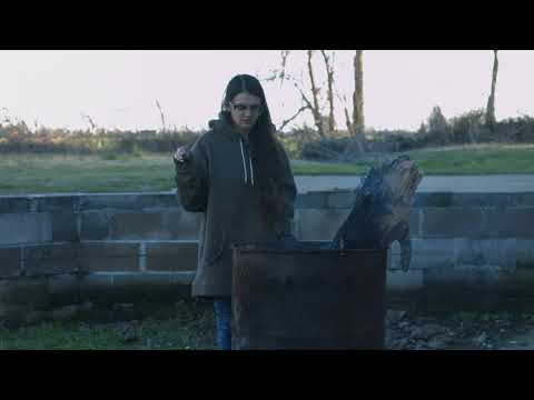 Young Woman Tends Dumpster Fire 4K