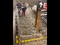 Water gushes down subway stairs during flooding in NYC