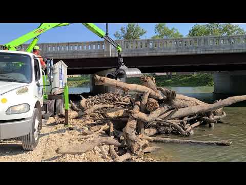 Muncie Sanitary District Peterson Claw Truck Picking up Logs