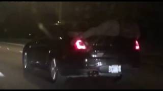 Video of Man Sleeping On Car Trunk Lid for 14 Miles, Car Moving at 65 MPH