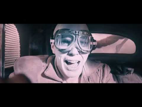 Mad Max Fury Road main trailer frame of War Rig racing through the desert