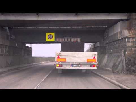 Truck gets stuck under low bridge