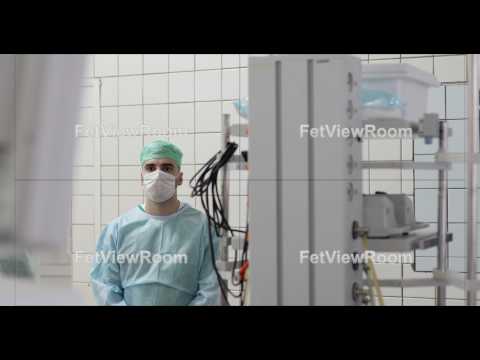 A young doctor wearing a mask and uniform is standing in the operating room