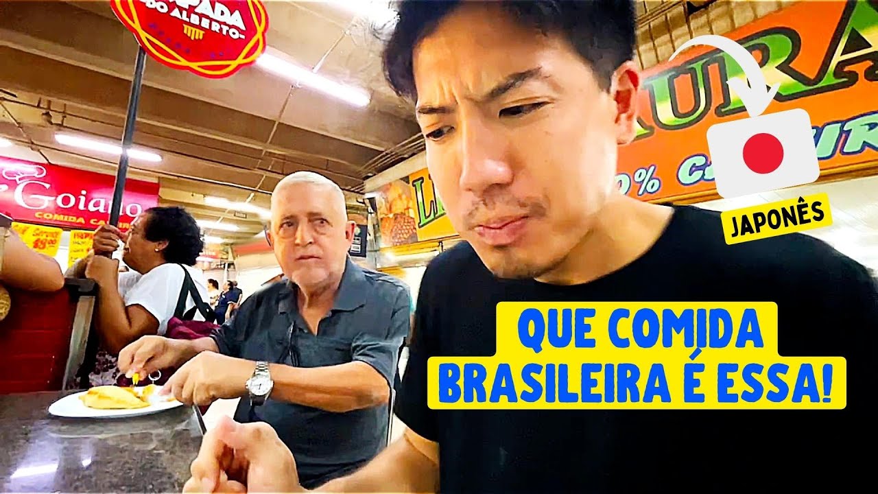 Japonês provando comida regional do Brasil, em Goiânia