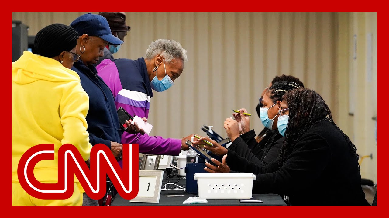 Georgia saw record turnout for first day of early voting. Analysts explain what it may mean