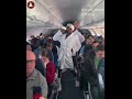 Dancing on the plane with robes on (uncle Azeez)