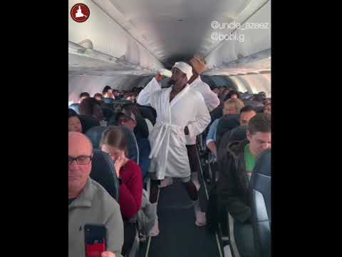 Dancing on the plane with robes on (uncle Azeez)