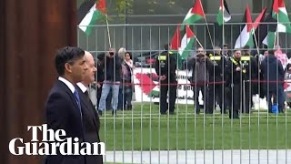 Military band almost drowns out pro-Palestine protesters as Sunak visits Scholz