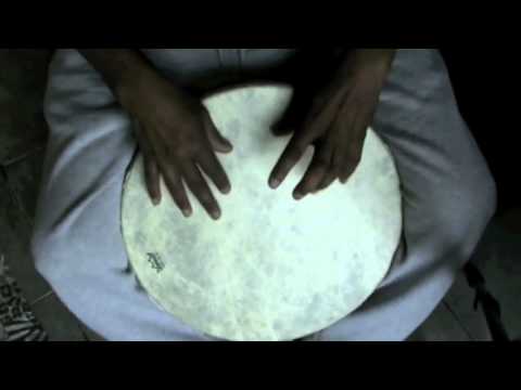 Eugene Skeef improvising on a frame drum to attain rhythmic balance.