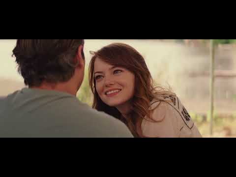 Irrational Man trailer frame: Joaquin Phoenix and Emma Stone crossing a sunlit quad while the piano hook from 'The In Crowd' seems to stride with them