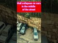 Wall collapses on cars after rain