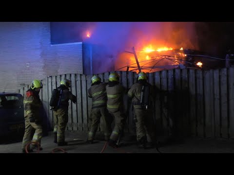 Brandweer forceert schutting voor een Middelbrand aan de Vilderdijk in Oss