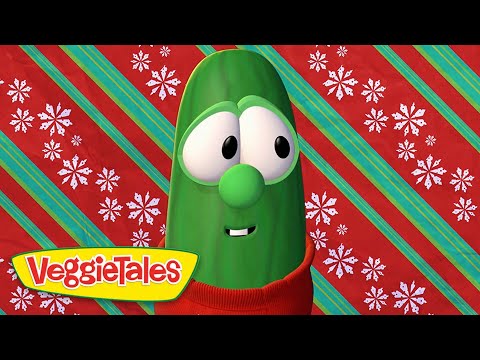 Green VeggieTales character (Bob the Tomato) wearing a red sweater, against a red and teal striped holiday backdrop with snowflakes, VeggieTales logo visible.