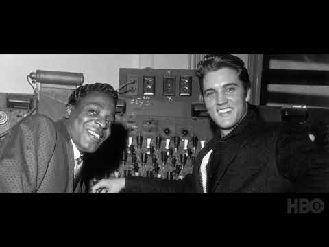 Trailer frame: close-up of Elvis in black-leather 1968 special, sweat and grin under hot lights