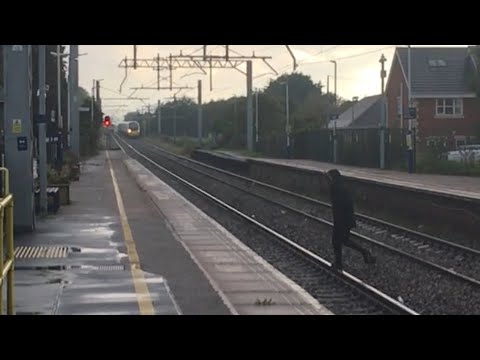 Person JUMPS ONTO RAILWAY TRACKS in front of 390 046