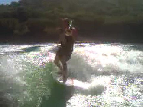 Adam Theis Playing Trombone while wakesurfing