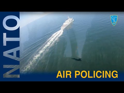 A Spanish Air Force F-18 fighter jet flying over NATO ships in the Baltic Sea