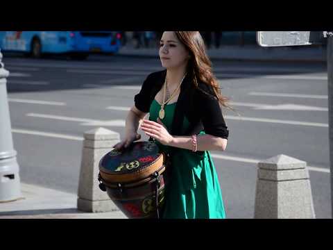 Sexy girl on Tverskaya street in Moscow, playing djembe