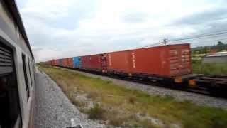 preview picture of video 'Passenger and Goods Trains Pass Between Pattaya and Bangkok Thailand'