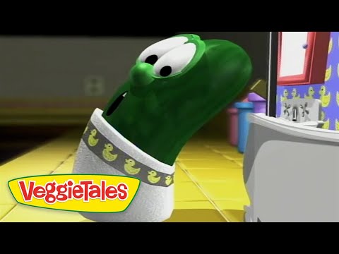Green VeggieTales character tilts head and looks toward a computer screen in a bright, yellow-tiled room; VeggieTales logo shown bottom-left.