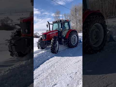 THE TRACTOR IS TRYING TO CLEAR THE SNOWY ROADS.