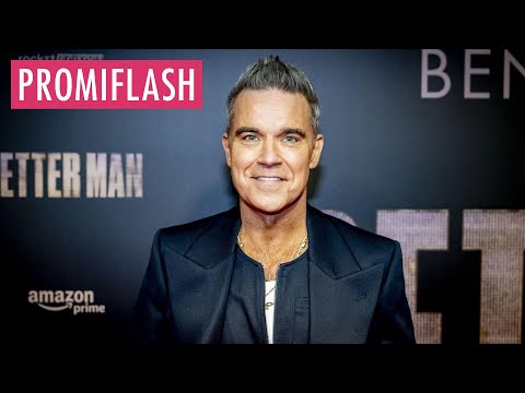 Robbie Williams enthüllt seine neuen Veneers in Live-Show