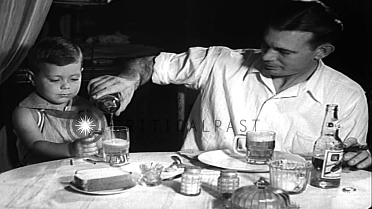 Two year old boy, Albert Lewis Jr., smokes a cigar and drinks beer with his fathe...HD Stock Footage