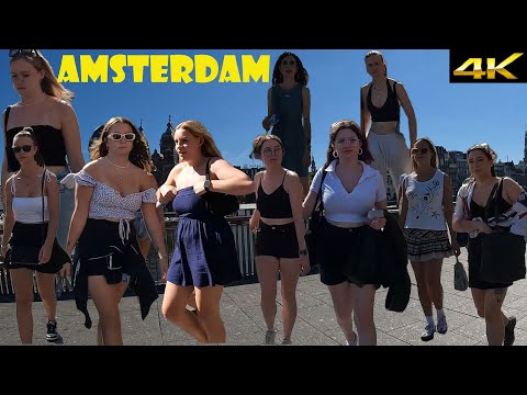 Amsterdam walking tour at Damrak street. A sunny day in September.