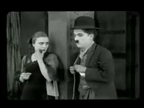 Edna Purviance flirts and dances with Charlie Chaplin
