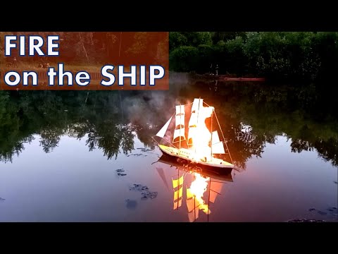 Ship on fire. Paper ship model is burning and sinking