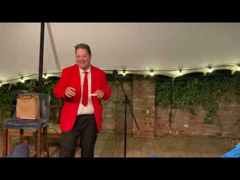 Red suit stand up comedy magic
