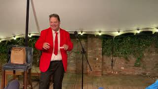 Red suit stand up comedy magic