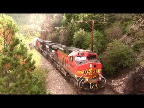 BNSF freight train climbs the steep Rocky mountain grade at full throttle.