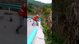 The process of installing wave shaped guardrails  Clever methods assist the work