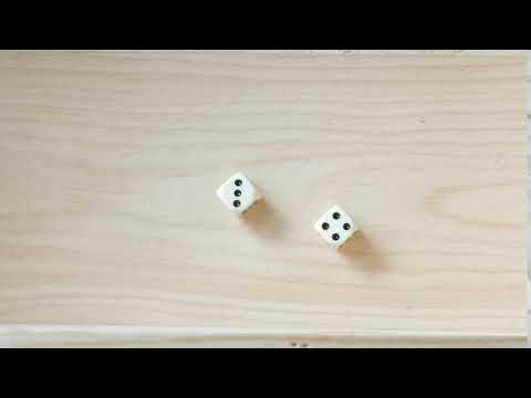 rolling dice on a wooden board with result