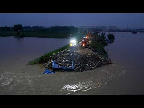 Live: Emergency crews work to seal Jialu River levee breach in Henan