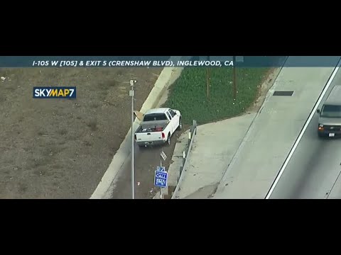 White pickup truck driving on shoulder in CA