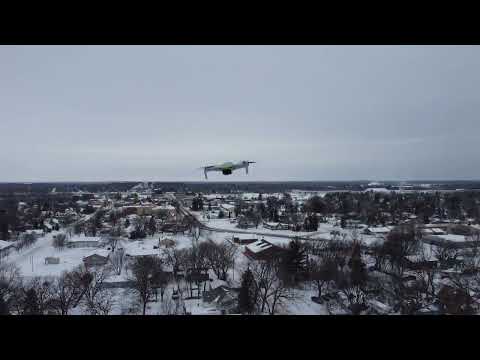 DJI Mini2 in flight above small town