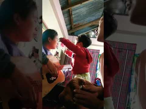 Son trying to put mask to his mom while singing.